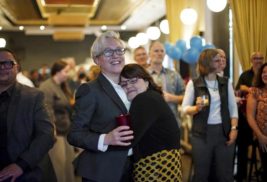 Tina Kotek, left, embraced by her wife, Aimee Kotek Wilson — Photo by Beth Nakamura / The Oregonian via AP