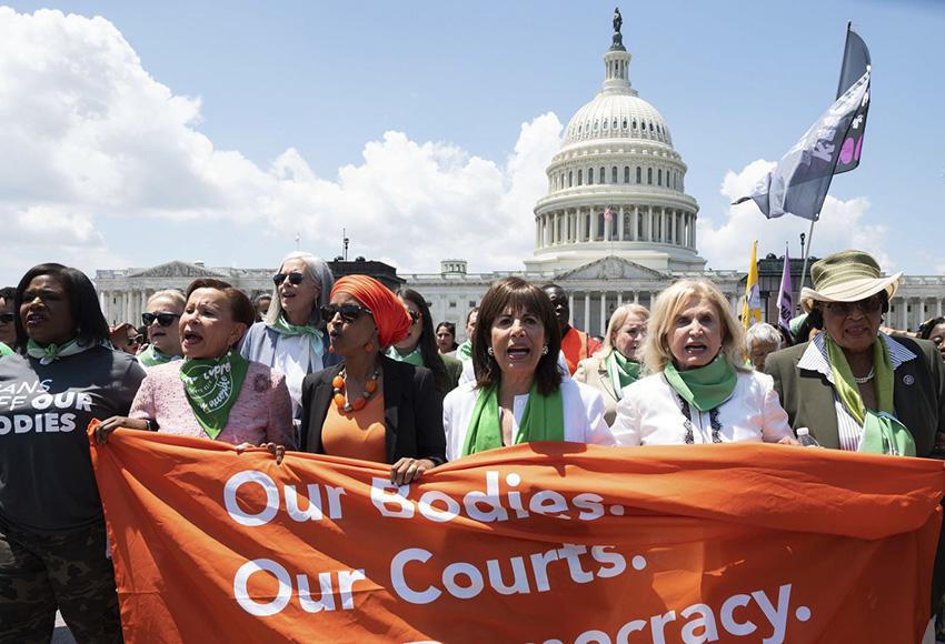 (from l) Rep. Cori Bush, D-Mo., Rep. Nydia Velazquez, D-N.Y., Rep. Ilhan Omar, D-Minn., Rep. Jackie Speier, D-Calif., Rep. Carolyn Maloney, D-Calif., and Rep. Alma Adams, D-N.C., carry a banner during a march for abortion rights, organized by the Center for Popular Democracy Action, outside the Capitol on Tuesday, July 19, 2022 in Washington. — Photo by Kevin Wolf / AP