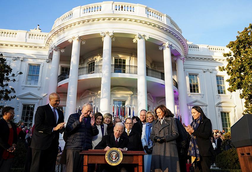 President Joe Biden signs the Respect for Marriage Act, Tue. Dec. 13, 2022, on the South Lawn of the White House in Washington — Photo by Kevin Lamarque / Reuters