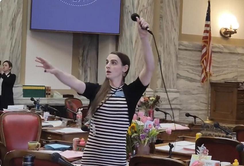 Democratic State Rep. Zooey Zephyr hoists a microphone into the air Monday, April 24 as her supporters interrupt proceedings in the state House in Helena, Mont., by chanting "Let Her Speak!" — Photo by Amy Beth Hanson / AP