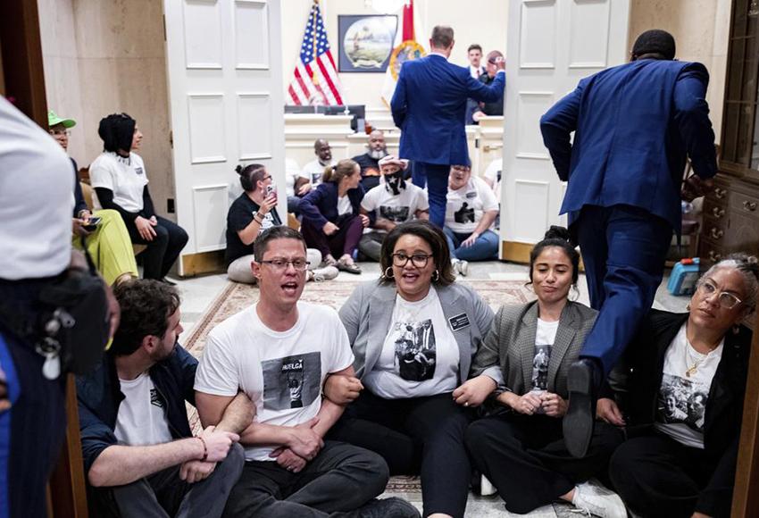 Activists staging a sit-in outside Florida Gov. Ron DeSantis's office — Photo by Alicia Devine / Tallahassee Democrat via AP