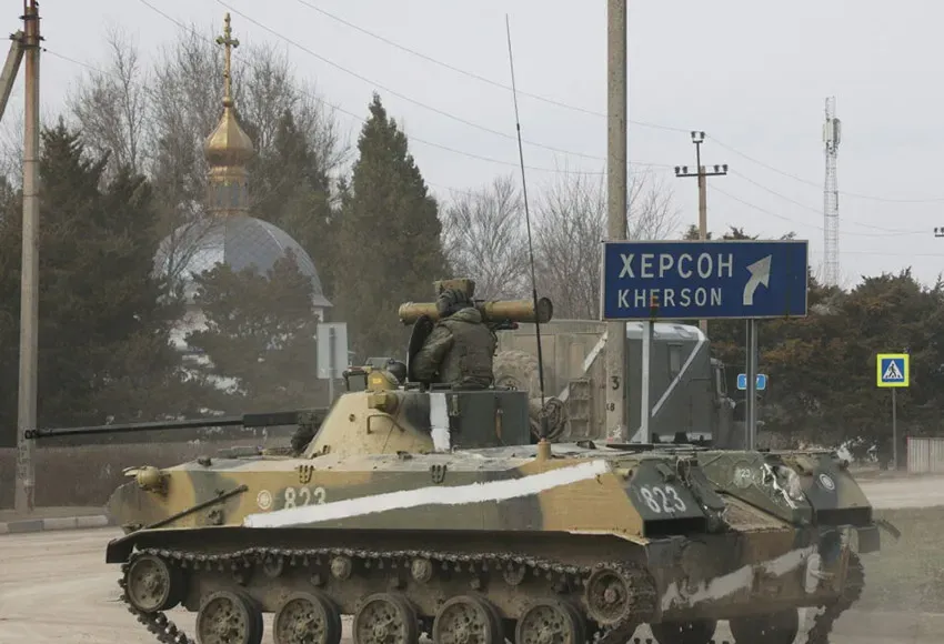 An armoured vehicle drives along a street, after Russian President Vladimir Putin authorized a military operation in eastern Ukraine, in the town of Armyansk, Crimea, Feb. 24, 2022 – Photo courtesy of Reuters / Stringer