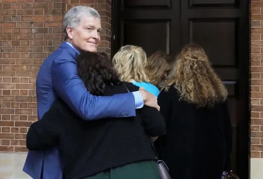 Steve Johnson, brother of the victim, hugs his wife at the Supreme Court in Sydney – Photo by Rick Rycroft / AP