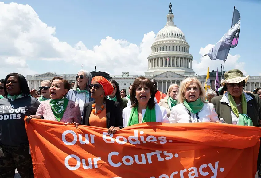 (from l) Rep. Cori Bush, D-Mo., Rep. Nydia Velazquez, D-N.Y., Rep. Ilhan Omar, D-Minn., Rep. Jackie Speier, D-Calif., Rep. Carolyn Maloney, D-Calif., and Rep. Alma Adams, D-N.C., carry a banner during a march for abortion rights, organized by the Center for Popular Democracy Action, outside the Capitol on Tuesday, July 19, 2022 in Washington. – Photo by Kevin Wolf / AP