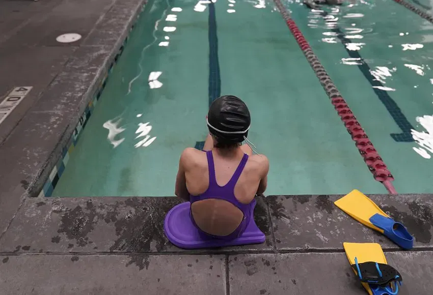 A 12-year-old Trans swimmer waits by a pool in Utah – Photo by Rick Bowmer / AP