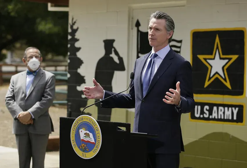 California Gov. Gavin Newsom at a news conference – Photo by Eric Risberg / AP