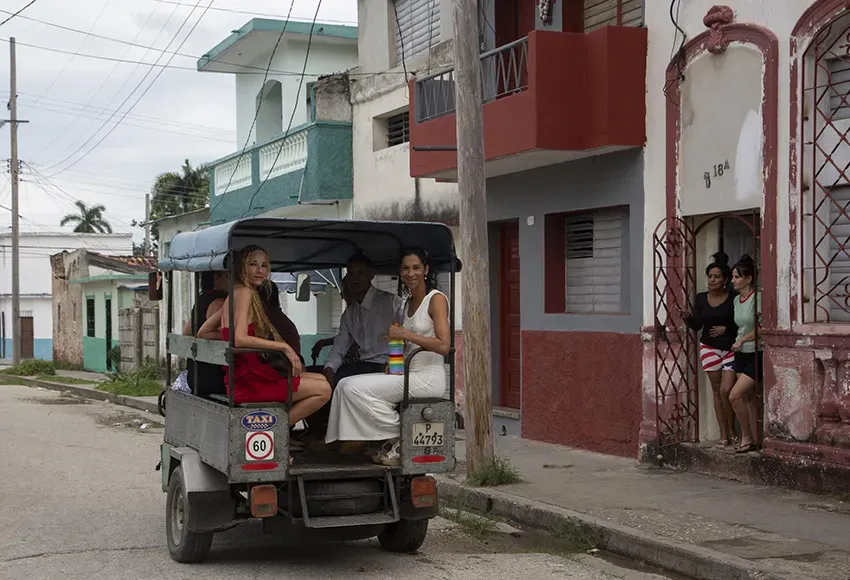 Brides Lisset Diaz Vallejo, (l) and Liusba Grajales travel in a taxi to the notary office to get married in Santa Clara, Cuba, Friday, Oct. 21, 2022. The couple, who have been together for seven years, is one of the first to make the decision to get legally married in Cuba following the new Family Code, which opened up everything from equal marriage to surrogate mothers. – Photo by Ismael Francisco / AP