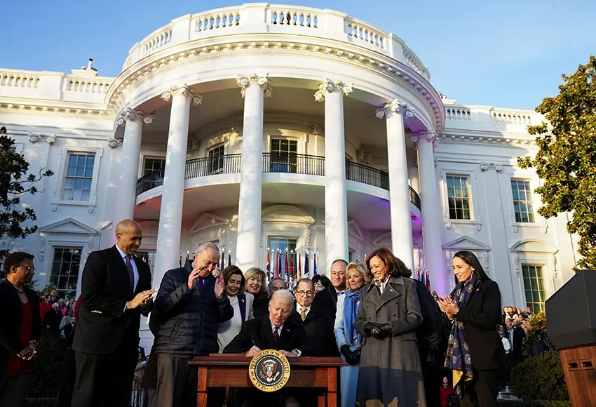 President Joe Biden signs the Respect for Marriage Act, Tue. Dec. 13, 2022, on the South Lawn of the White House in Washington – Photo by Kevin Lamarque / Reuters
