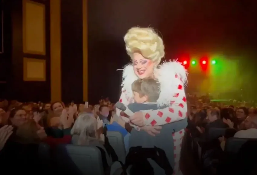 Drag queen Nina West hugs a child in the audience at a recent performance – Image courtesy of Murray & Peter
