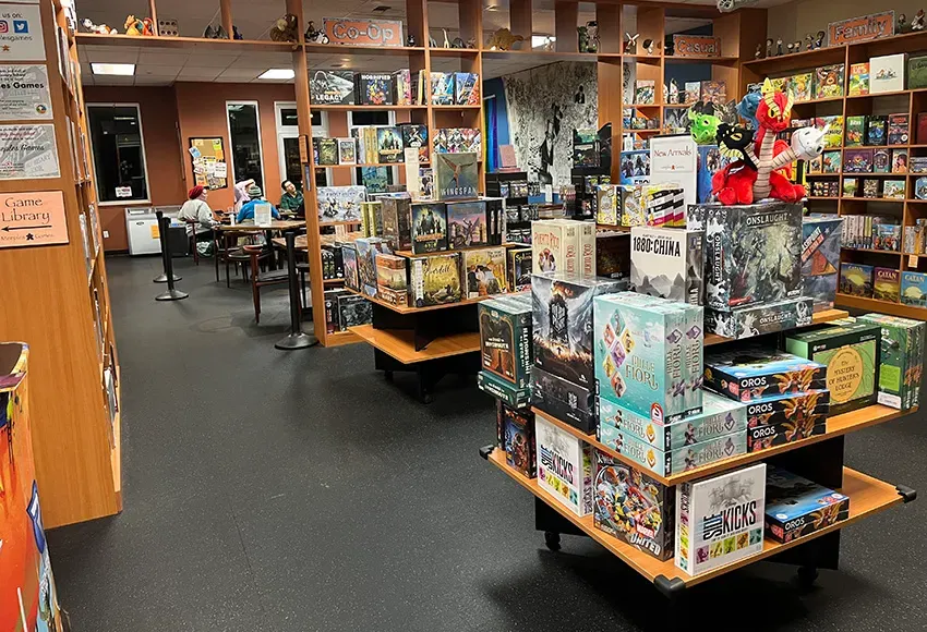 Stacks of board games, a Dungeons & Dragons group beyond – Photo by Daniel Lindsley