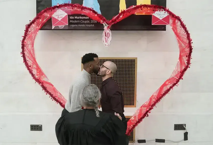 Jeremy Yancey (l) kisses Fabio de Andrade while getting married at City Hall in San Francisco, Tuesday, Feb. 14, 2023 – Photo by Jeff Chiu / AP