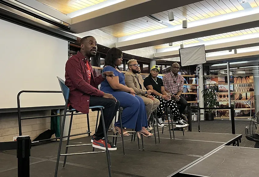 Deaunte Damper (l) moderates the LGBTQ panel with Andrew Ashiofu (r) – Photo by Daniel Lindsley