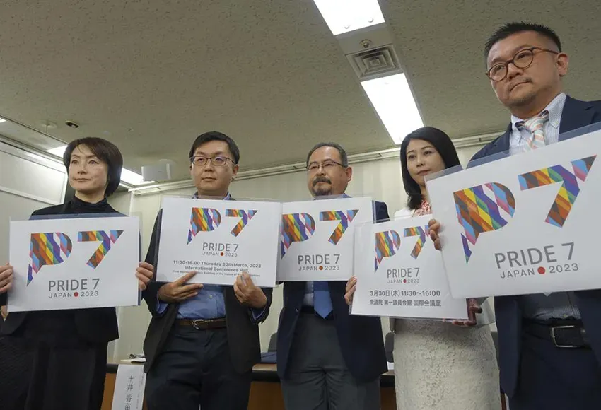 LGBTQ activists in Tokyo, holding cards for civil engagement group Pride7 – Photo by Mari Yamaguchi / AP