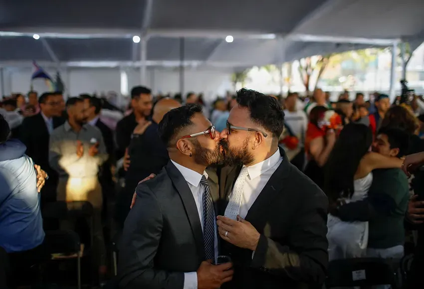 A couple kisses at a celebration in Mexico City  – Photo by Raquel Cunha / Reuters