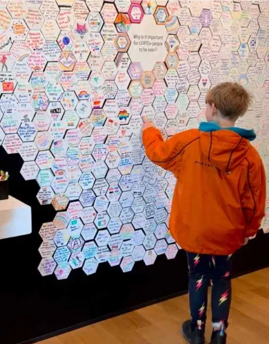 E. at the Queer Britain Museum in London last year, adding his thoughts to an exhibit about the importance of LGBTQ+ visibility. / Ali Moss